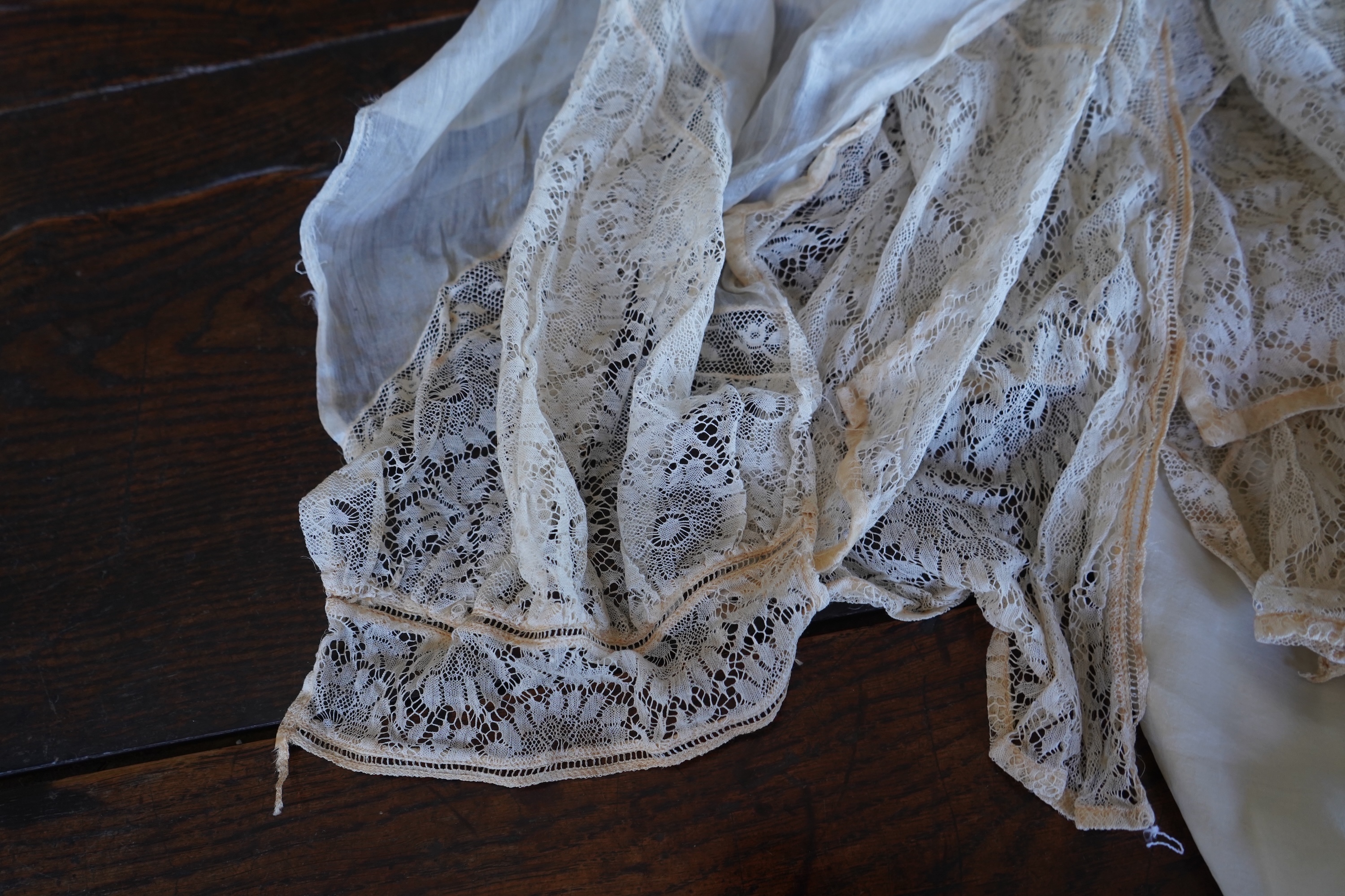 A collection of 1920's-30's silk and satin camisole slips, two cream silk and lace jackets, a lace blouse a silk embroidered blouse, a silk cami, and a collection of silk stockings., Condition- good